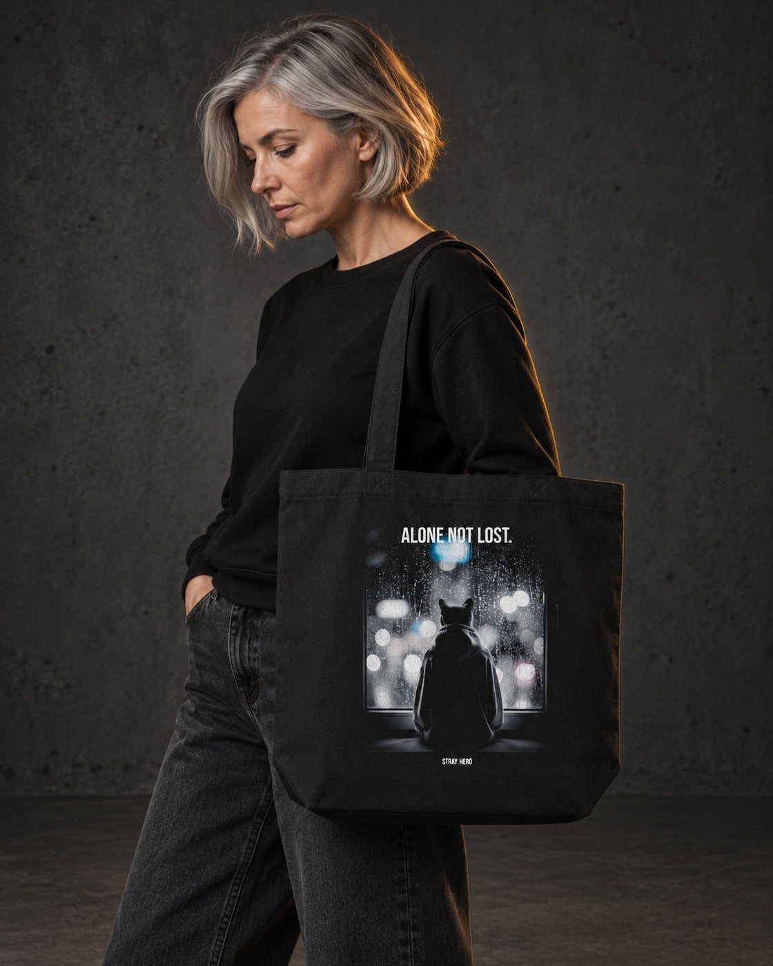 Alone Not Lost Organic Tote, carried, back print, black — AI-generated visual