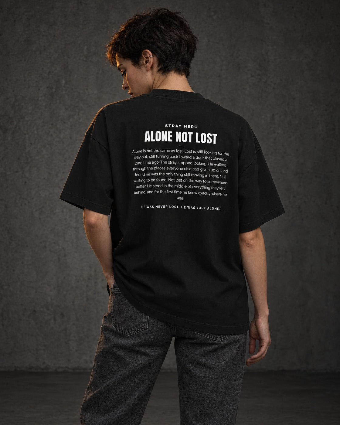 Alone Not Lost Story Tee Black, worn, back print, black — AI-generated visual