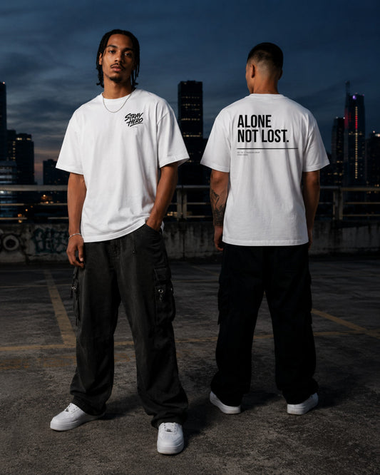Alone Not Lost — Tee · White — Lifestyle — AI-generated visual
