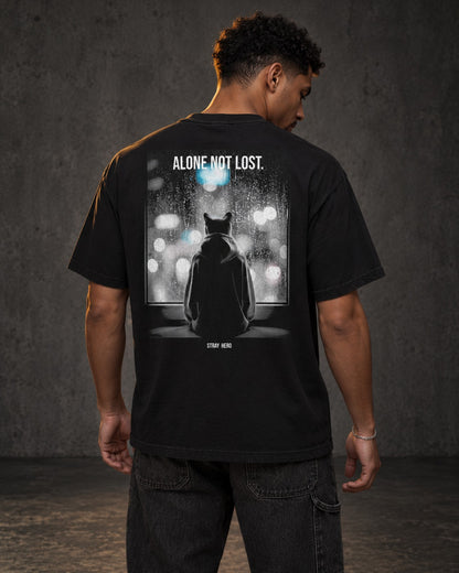 Alone Not Lost Tee Cinematic, worn, back print, black — AI-generated visual
