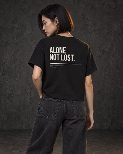 Alone Not Lost Women's Tee, worn, back print, black — AI-generated visual