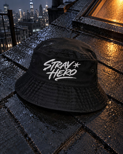 Signature Bucket Hat, front embroidery, black, on wet rooftop tiles beside a lit skylight at night — AI-generated visual