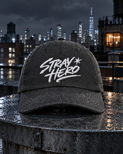 Signature 6-Panel Cap, front embroidery, graphite, on a wet rooftop water tank lid at night — AI-generated visual