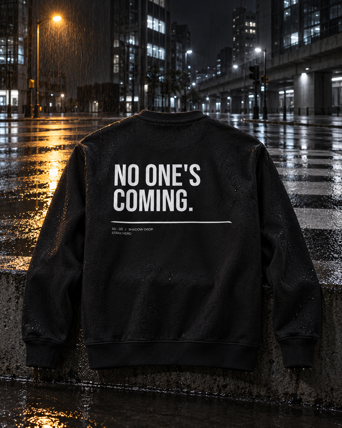 No One's Coming Sweatshirt Statement, back print, black, laid on a wet ledge by a city street at night — AI-generated visual
