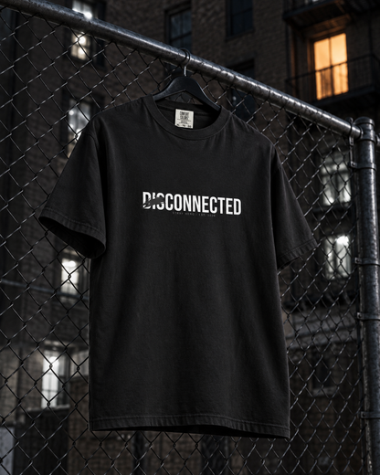 Disconnected Tee, front print, black, hanging on a chain-link fence in a backyard at night — AI-generated visual