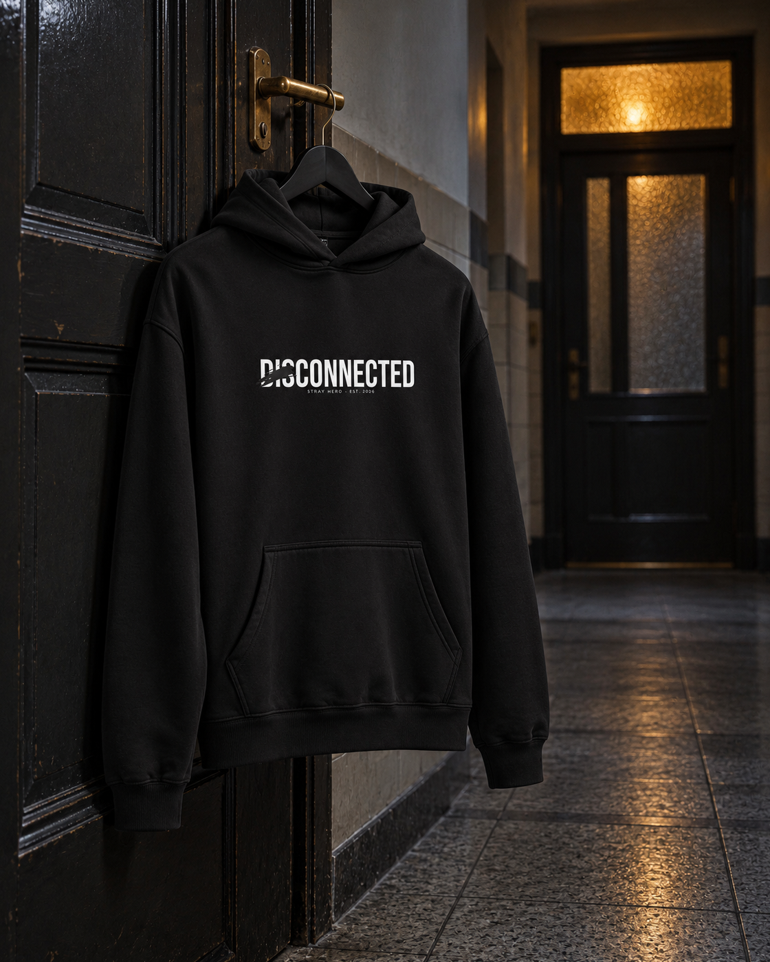 Disconnected Hoodie, front print, black, hanging on a door handle in a hallway at night — AI-generated visual
