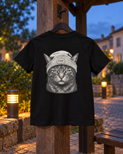 Ghost Kids Tee, back print, black, hanging on a wooden post beside a lit path at dusk — AI-generated visual