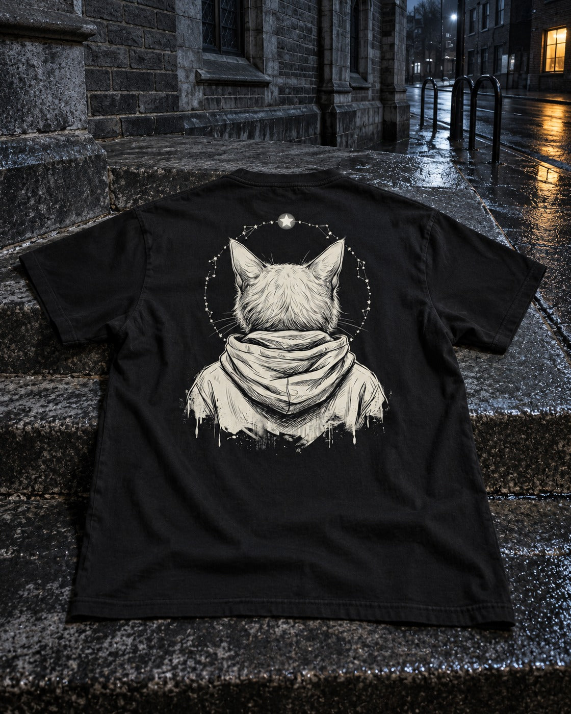 Patron Saint Tee, back print, black, laid on stone steps outside a city church — AI-generated visual