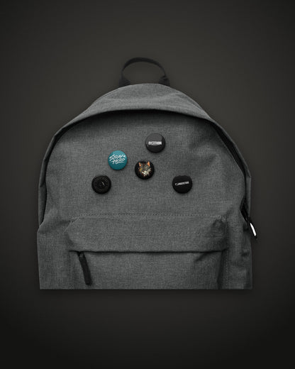 Pin Set, 1.25 inch buttons on a grey backpack