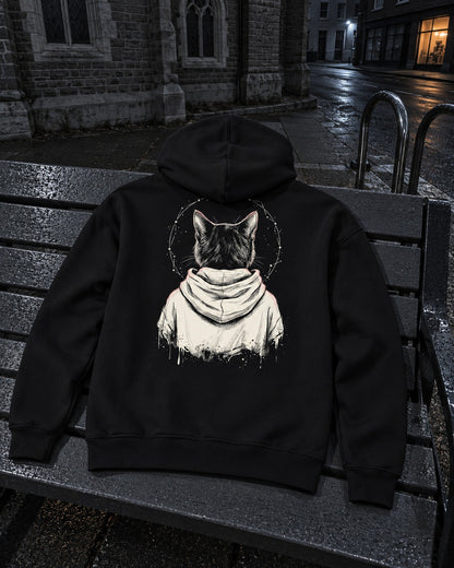 Rosary Hoodie, back print, black, draped over a bench outside a city church at night — AI-generated visual