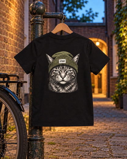 Shade Kids Tee, back print, black, hanging on a lamppost beside a bicycle in a brick alley at dusk — AI-generated visual