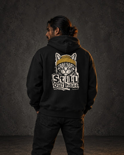 Still Out Here Hoodie, worn, back print, black — AI-generated visual
