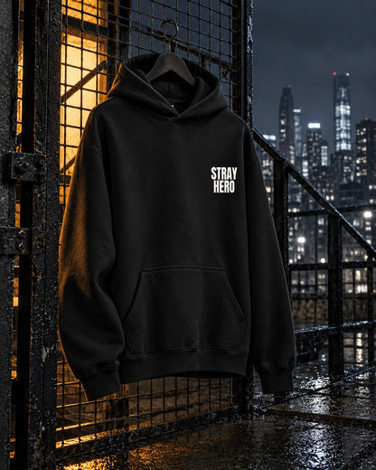 Insignia Hoodie, chest print, black, hanging on a rooftop safety cage with an amber-lit stairwell behind at night — AI-generated visual