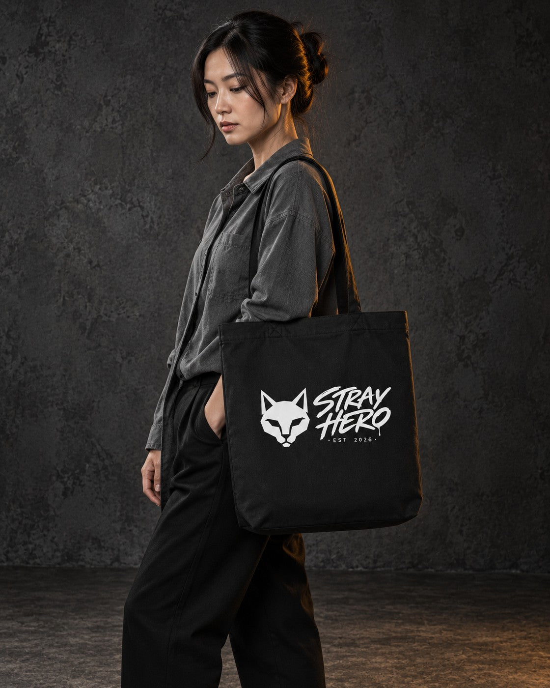 Stray Logo Organic Tote, carried, front print, black — AI-generated visual