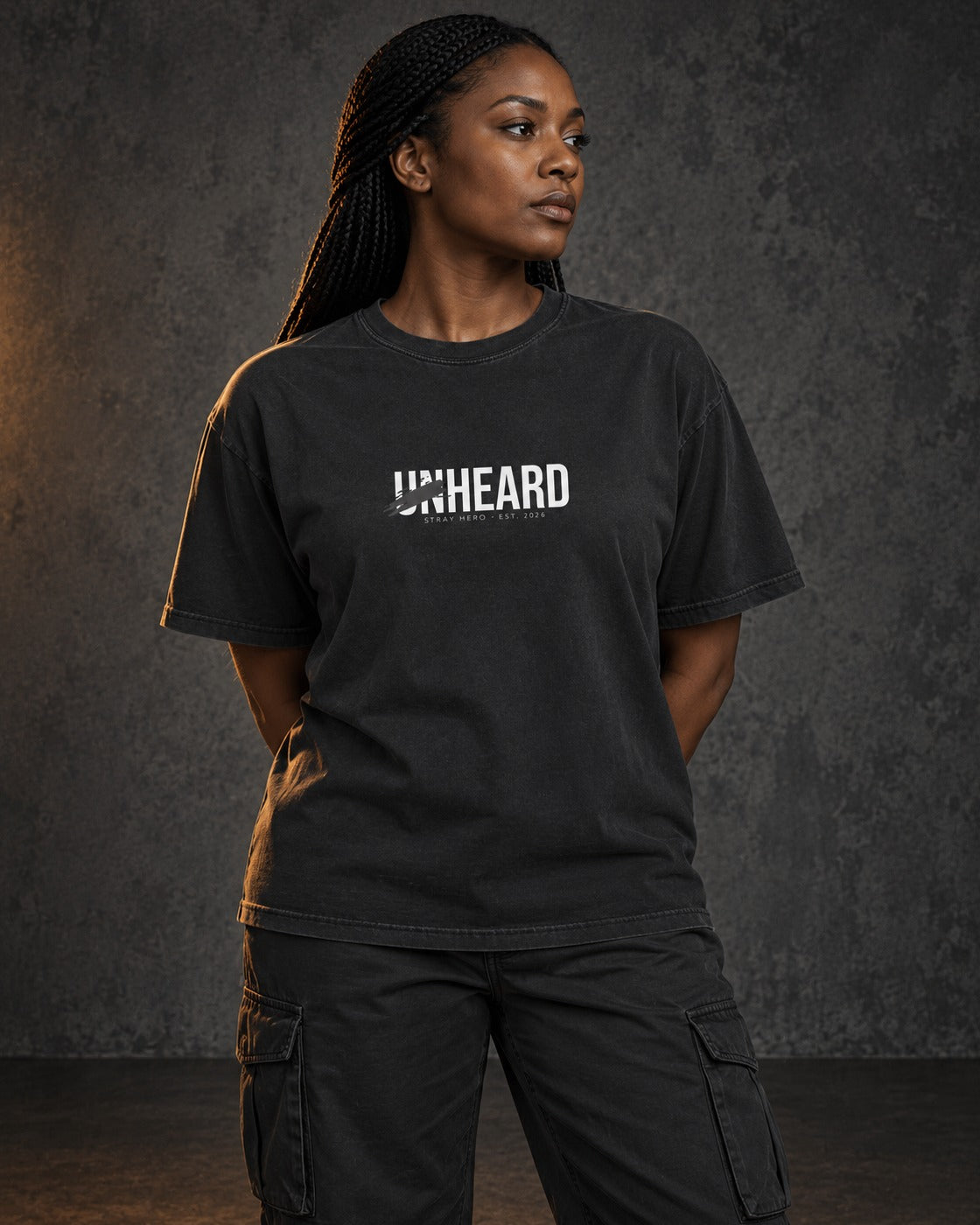 Unheard Tee, worn, front print, black — AI-generated visual