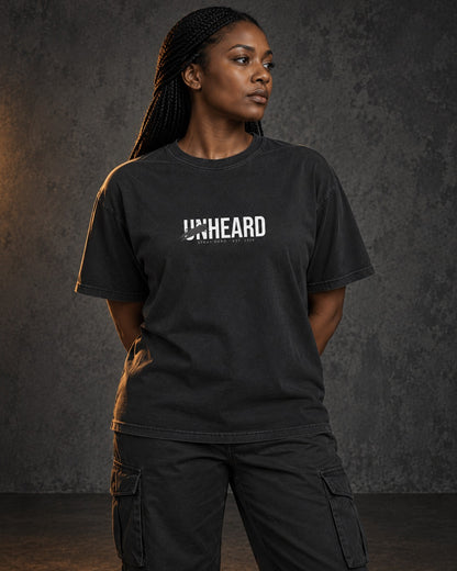 Unheard Tee, worn, front print, black — AI-generated visual